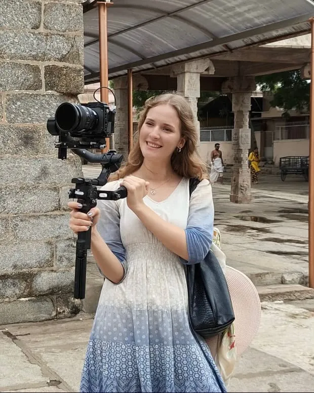 Mariia Ko on location in India, shooting with a gimbal-mounted camera at a temple